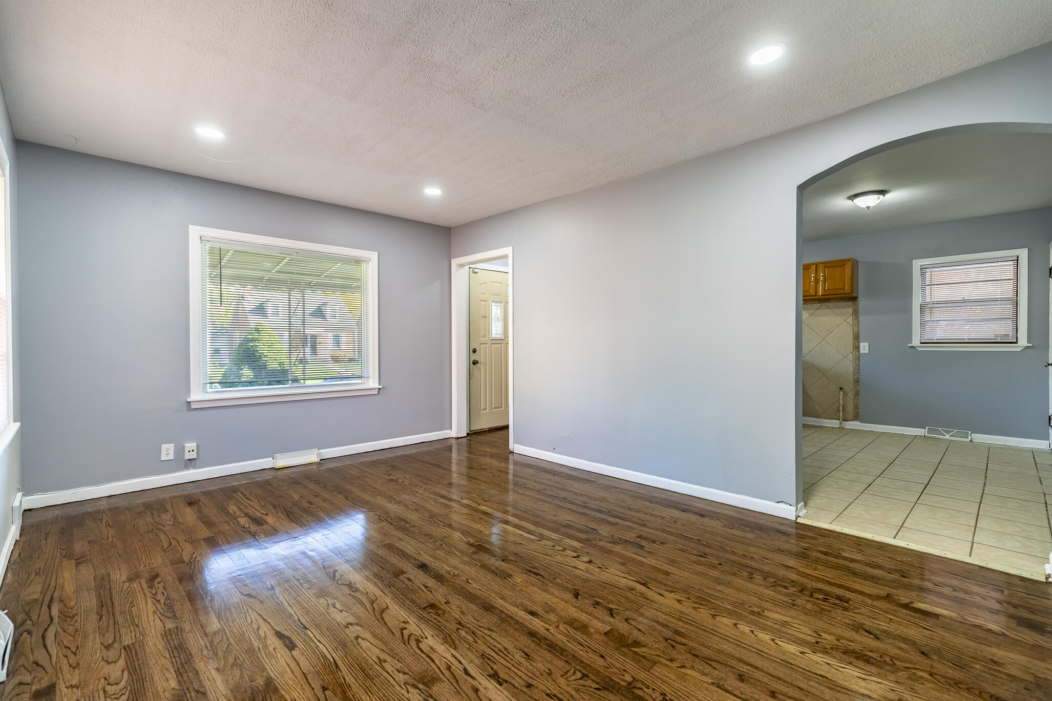 4836 Madison Street Gary, IN 46408 - Photo 8 of 21 an empty room with window and wooden floor