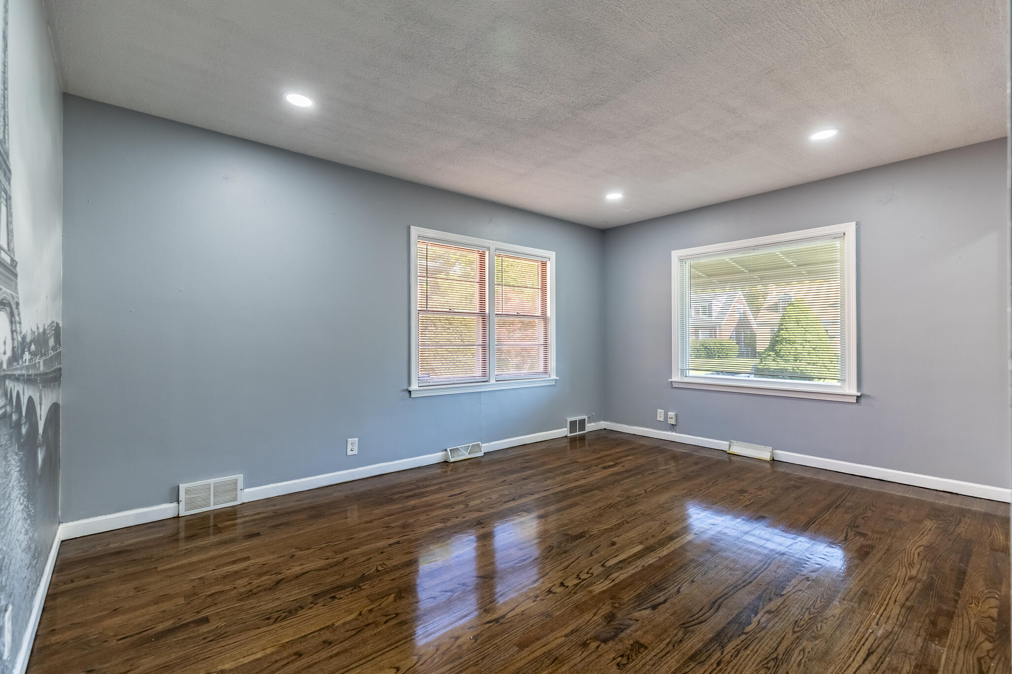 4836 Madison Street Gary, IN 46408 - Photo 9 of 21 an empty room with wooden floor and windows