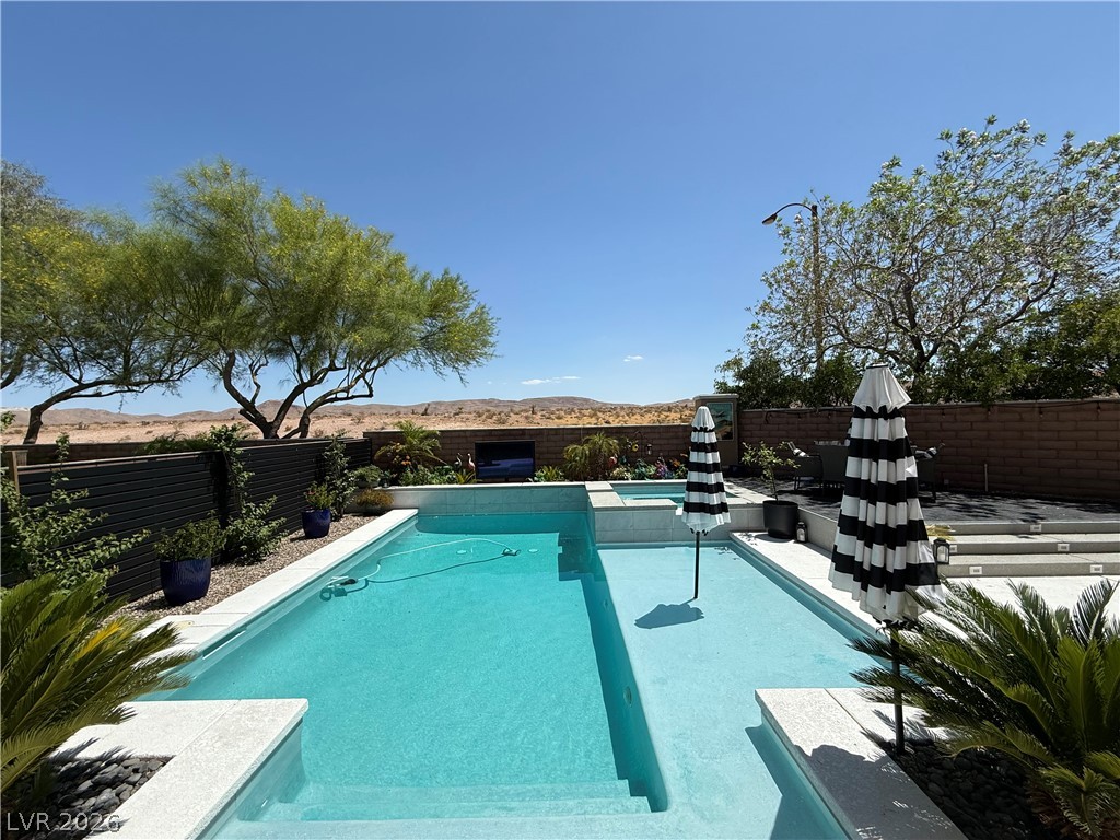 7895 Red Rock Ridge Avenue Las Vegas, NV 89179 - Photo 3 of 3 A desert oasis awaits with this sparkling pool, perfect for outdoor enjoyment and relaxation.