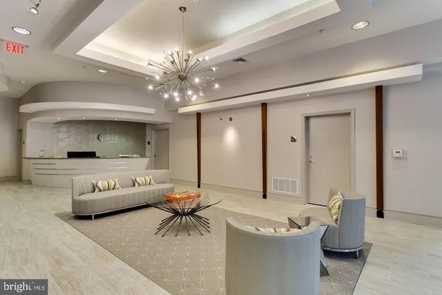 a living room with furniture and a chandelier