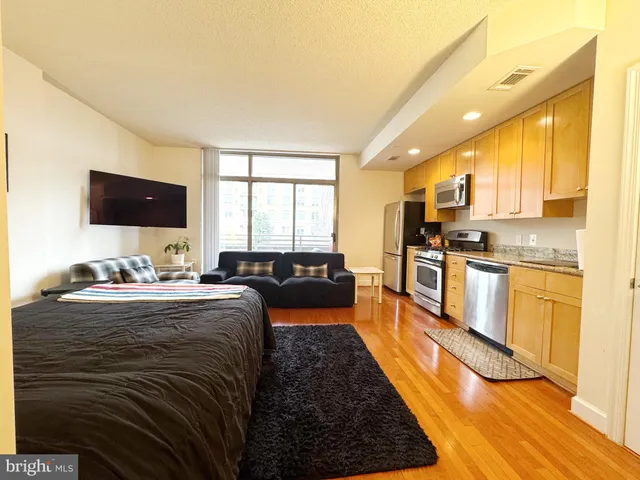 a large kitchen with stainless steel appliances granite countertop a stove and a sink