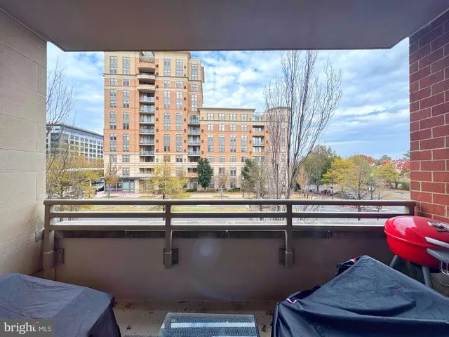 a view of a kitchen with granite countertop a sink and wooden floor