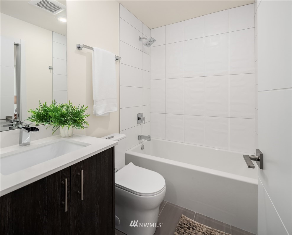 13735 35th Avenue Northeast, Unit B Seattle, WA 98125 - Photo 11 of 20 a bathroom with a sink a toilet and a bathtub