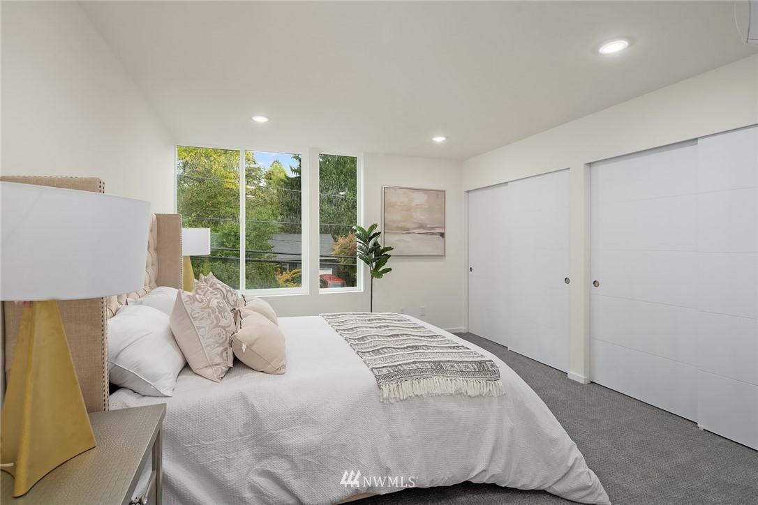 13735 35th Avenue Northeast, Unit B Seattle, WA 98125 - Photo 13 of 20 a spacious bedroom with a bed and a large window