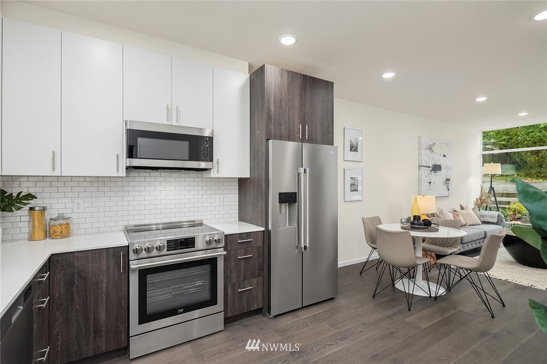 13735 35th Avenue Northeast, Unit B Seattle, WA 98125 - Photo 8 of 20 a kitchen with stainless steel appliances a stove a sink a microwave a refrigerator and cabinets