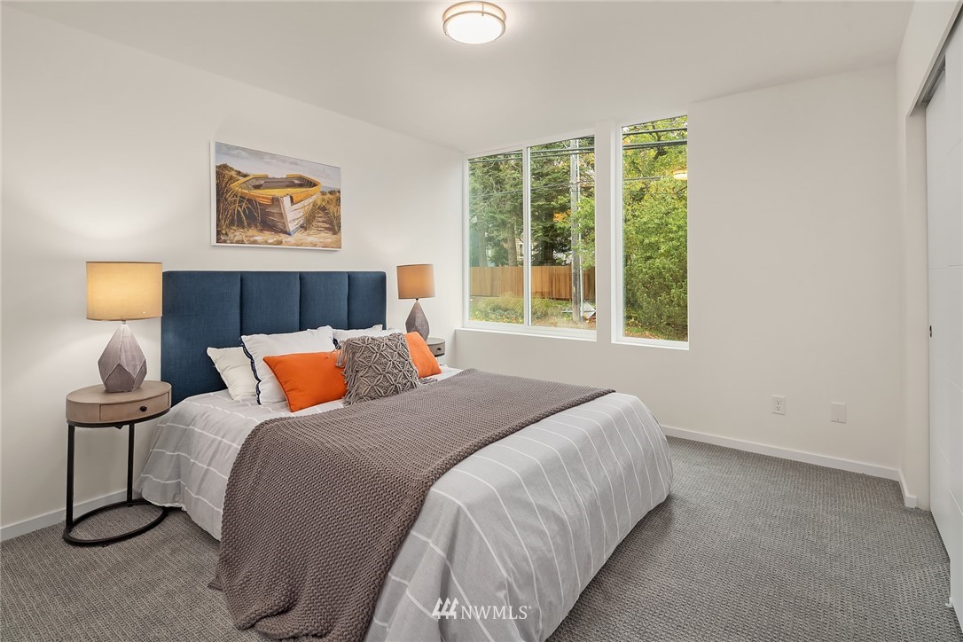 13735 35th Avenue Northeast, Unit B Seattle, WA 98125 - Photo 9 of 20 a bed sitting in a bedroom next to a window
