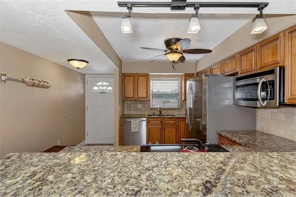 a view of a kitchen with a sink cabinets and wooden floor