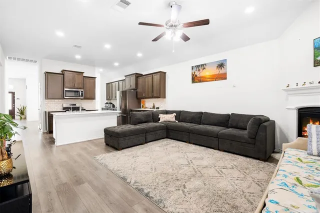 a living room with furniture and a fireplace
