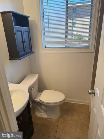a white toilet sitting next to a bathroom sink