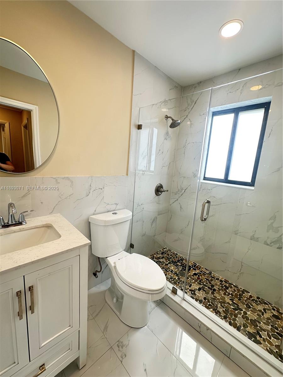 97 Northwest 73rd Place, Unit 12 Miami, FL 33126 - Photo 11 of 20 a bathroom with a sink toilet and shower