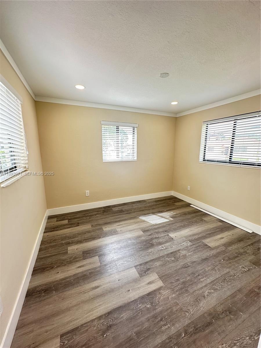 97 Northwest 73rd Place, Unit 12 Miami, FL 33126 - Photo 12 of 20 wooden floor in an empty room with a window