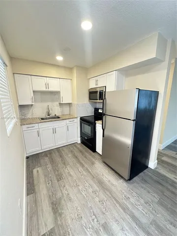 a kitchen with a refrigerator a sink and dishwasher