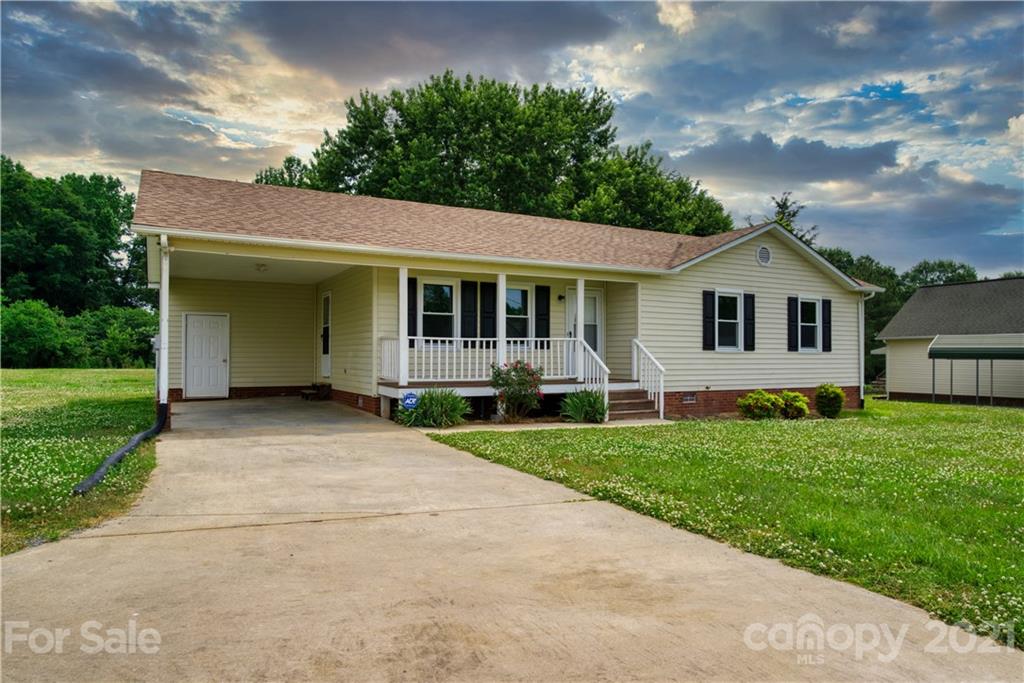 2345 Sides Road Rockwell, NC 28138 - Photo 17 of 19 a front view of a house with a garden