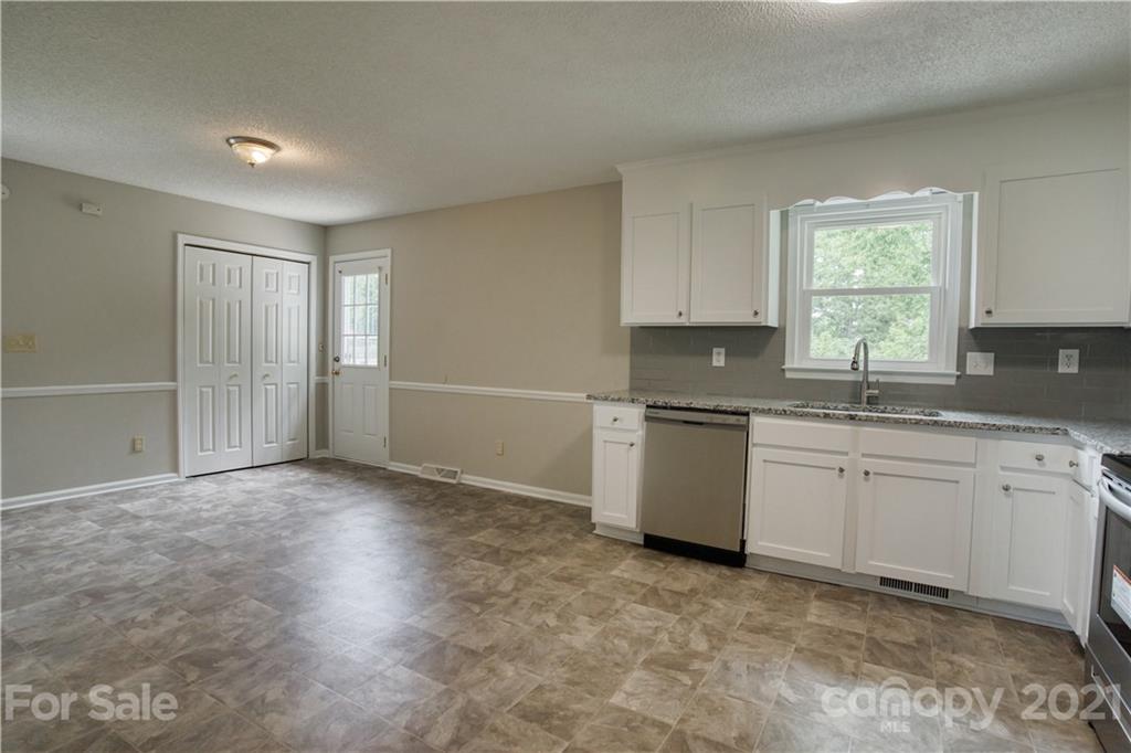 2345 Sides Road Rockwell, NC 28138 - Photo 6 of 19 a kitchen with granite countertop a sink cabinets stainless steel appliances and a window