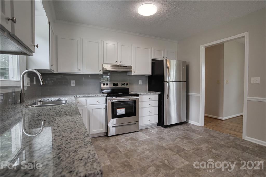 2345 Sides Road Rockwell, NC 28138 - Photo 7 of 19 a kitchen with stainless steel appliances granite countertop a refrigerator sink and stove