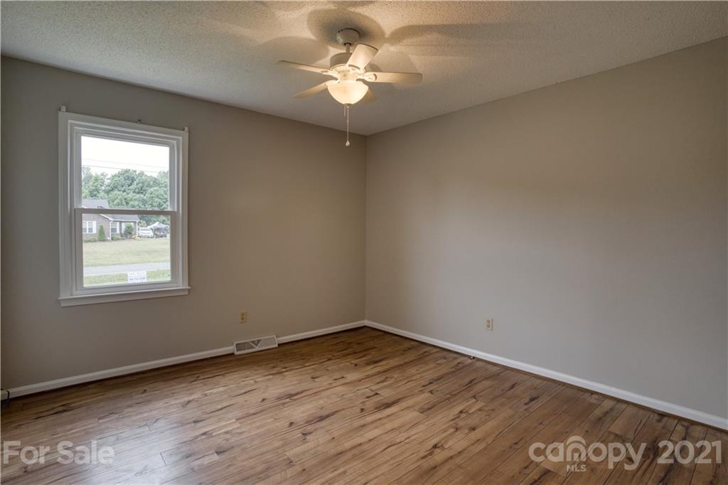 2345 Sides Road Rockwell, NC 28138 - Photo 8 of 19 an empty room with a window and a ceiling fan
