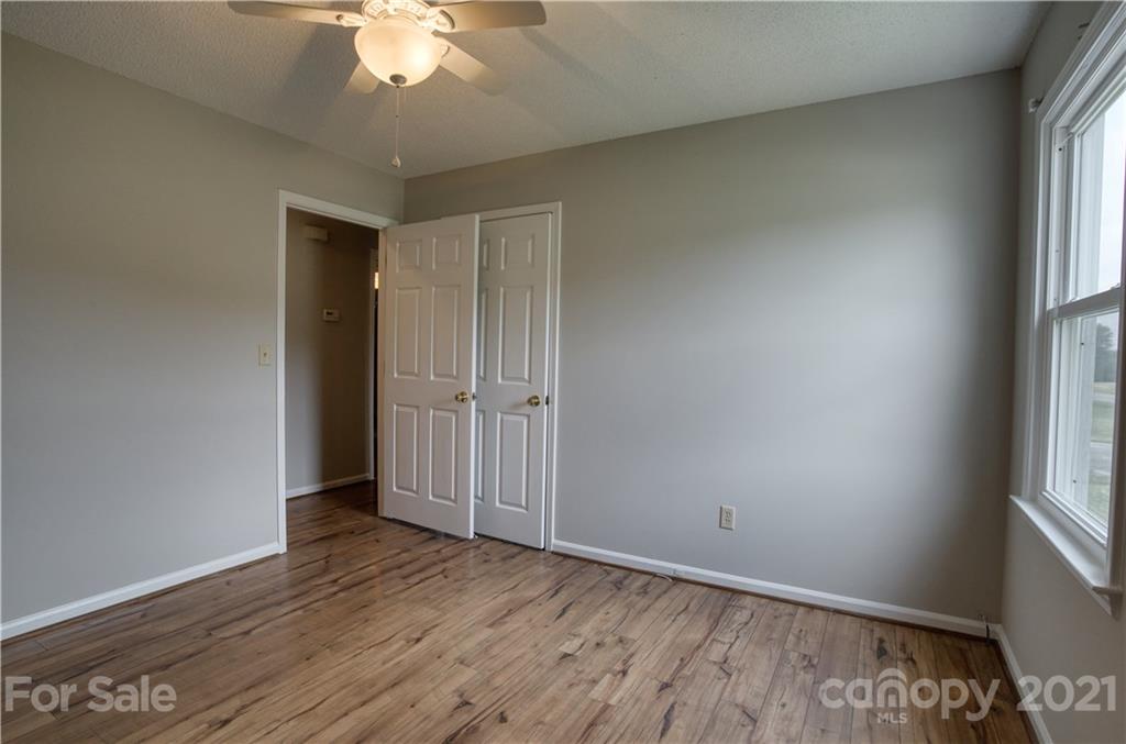 2345 Sides Road Rockwell, NC 28138 - Photo 9 of 19 an empty room with wooden floor and windows