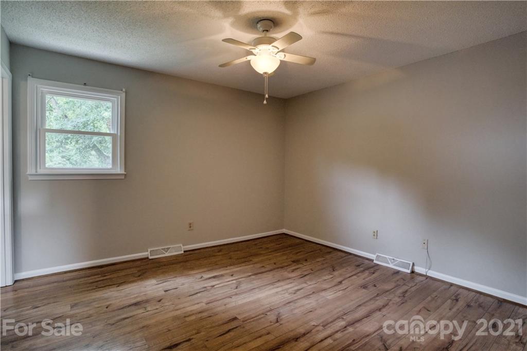 2345 Sides Road Rockwell, NC 28138 - Photo 10 of 19 a big room with wooden floor a chandelier fan and windows