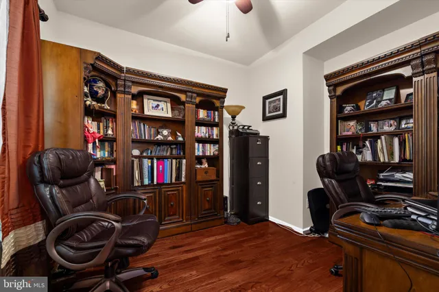 a bedroom with bed and paintings on the wall