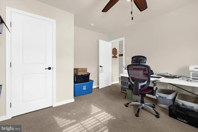 a living room with furniture and a gym equipment