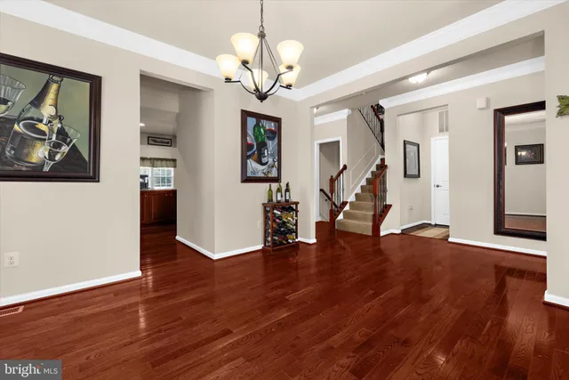 a view of an entryway with wooden floor and stairs