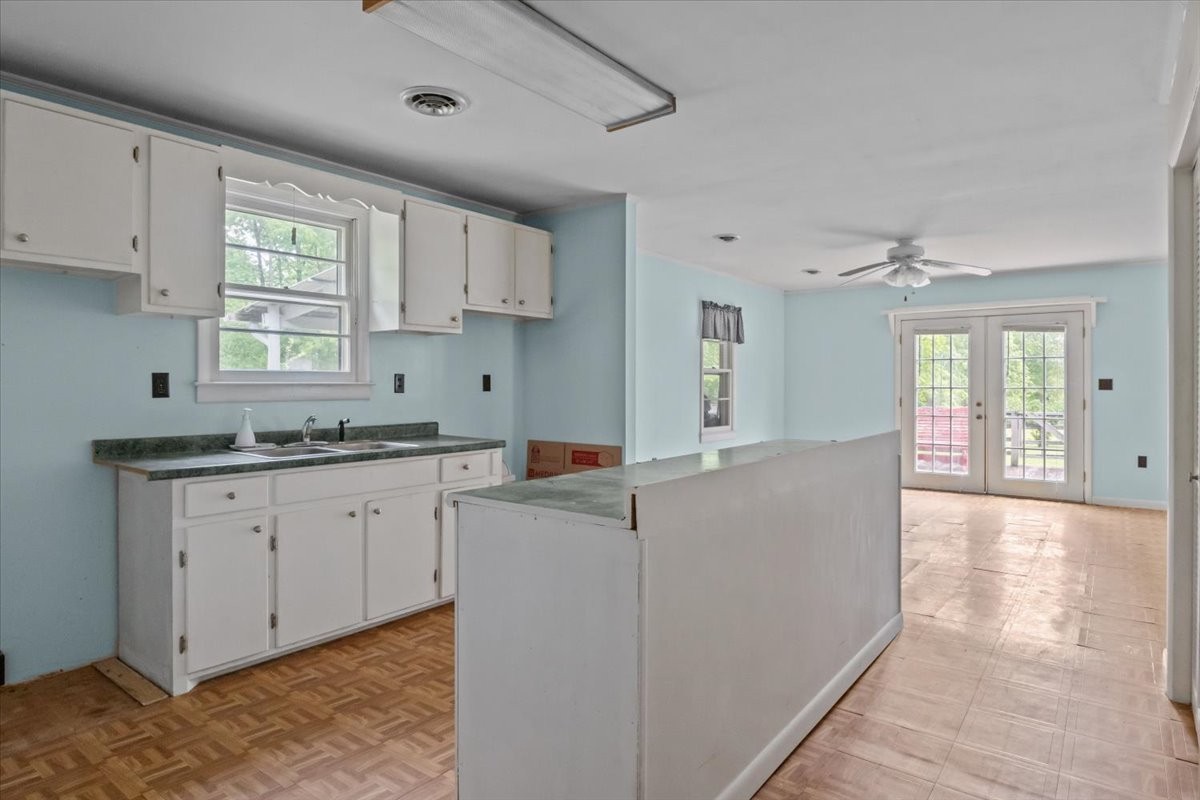 7158 Bahne Road Fairview, TN 37062 - Photo 12 of 37 a large white kitchen with granite countertop a sink window and cabinets