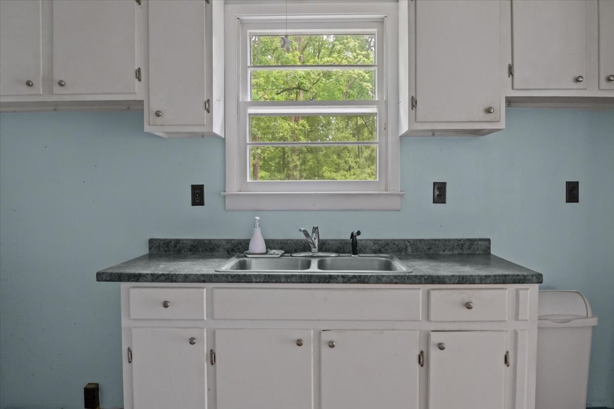 7158 Bahne Road Fairview, TN 37062 - Photo 13 of 37 a kitchen with granite countertop white cabinets and a window