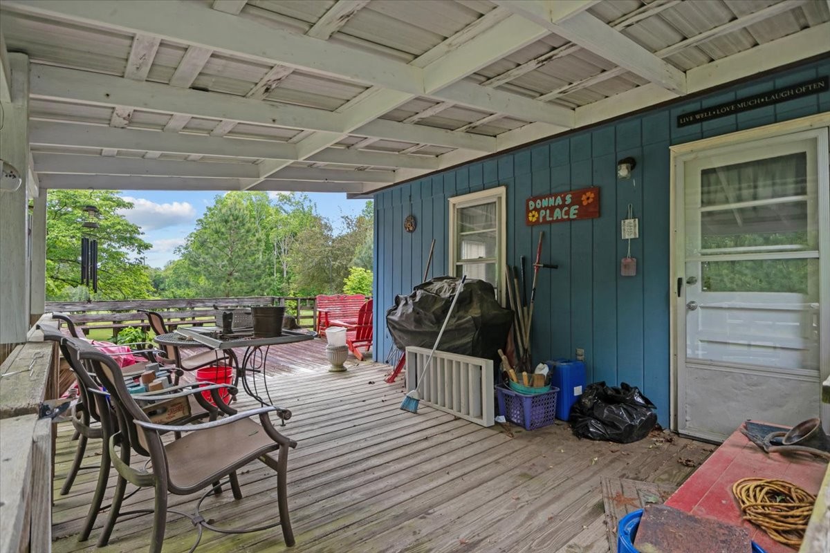 7158 Bahne Road Fairview, TN 37062 - Photo 29 of 37 a view of a deck with table and chairs a barbeque with wooden floor