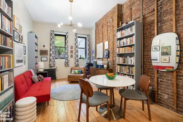 a view of a dining room with furniture and a book shelf