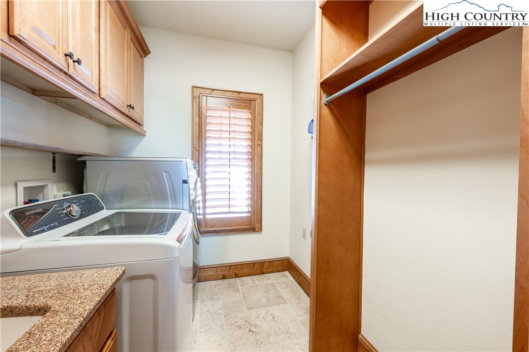 311 Penny Lane, Unit 2D Banner Elk, NC 28604 - Photo 15 of 38 a utility room with a sink a washer and dryer