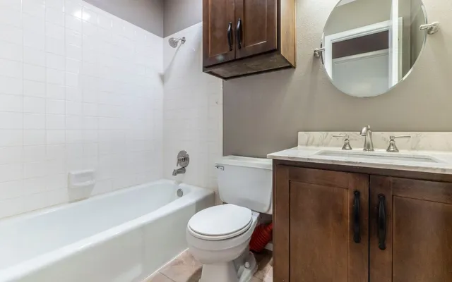 a bathroom with a sink toilet and bathtub