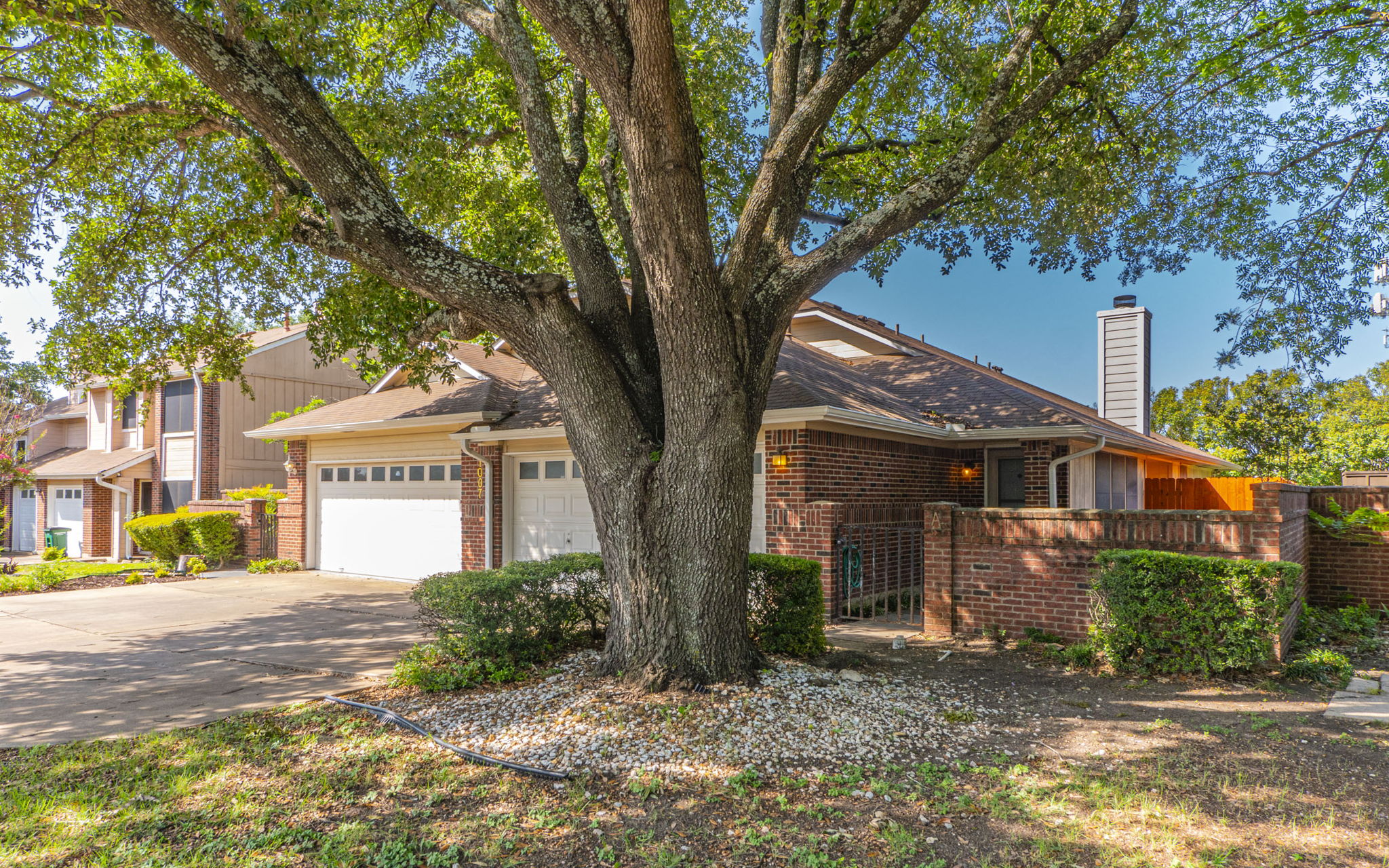 1007 Markham Lane, Unit A Austin, TX 78753 - Photo 4 of 15 a front view of a house with a tree