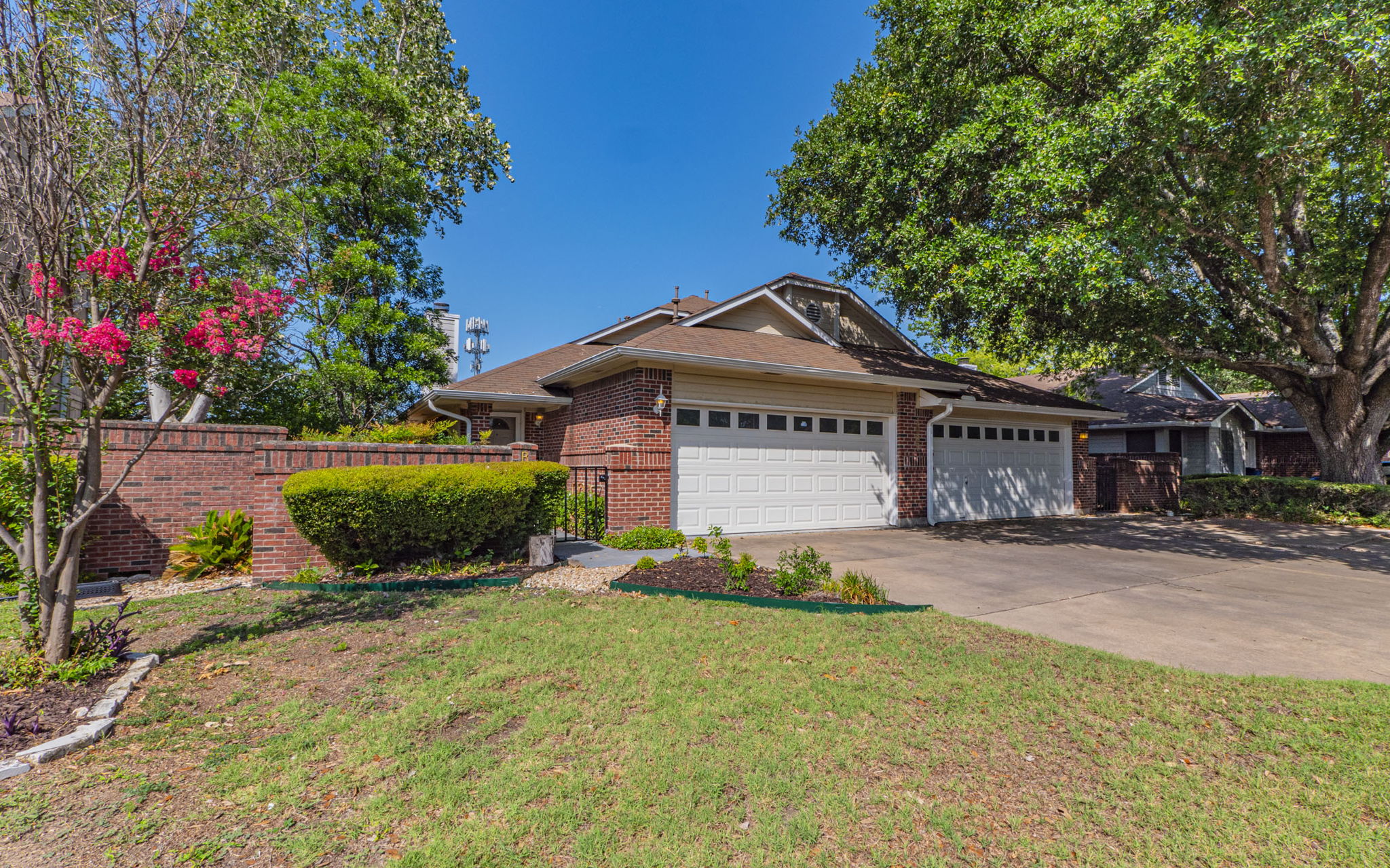 1007 Markham Lane, Unit A Austin, TX 78753 - Photo 5 of 15 a front view of a house with a yard and garage