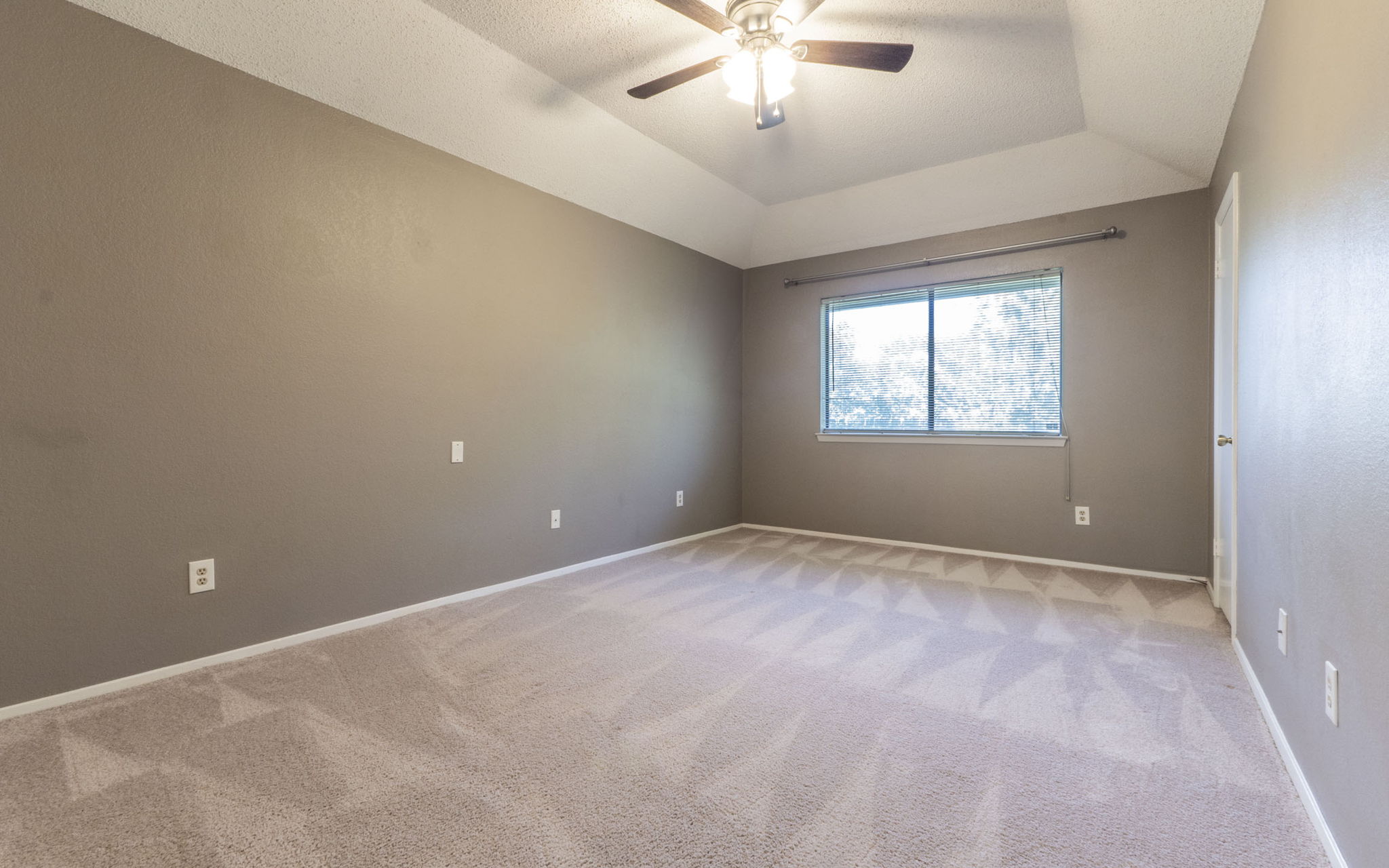 1007 Markham Lane, Unit A Austin, TX 78753 - Photo 8 of 15 an empty room with a window and a chandelier fan