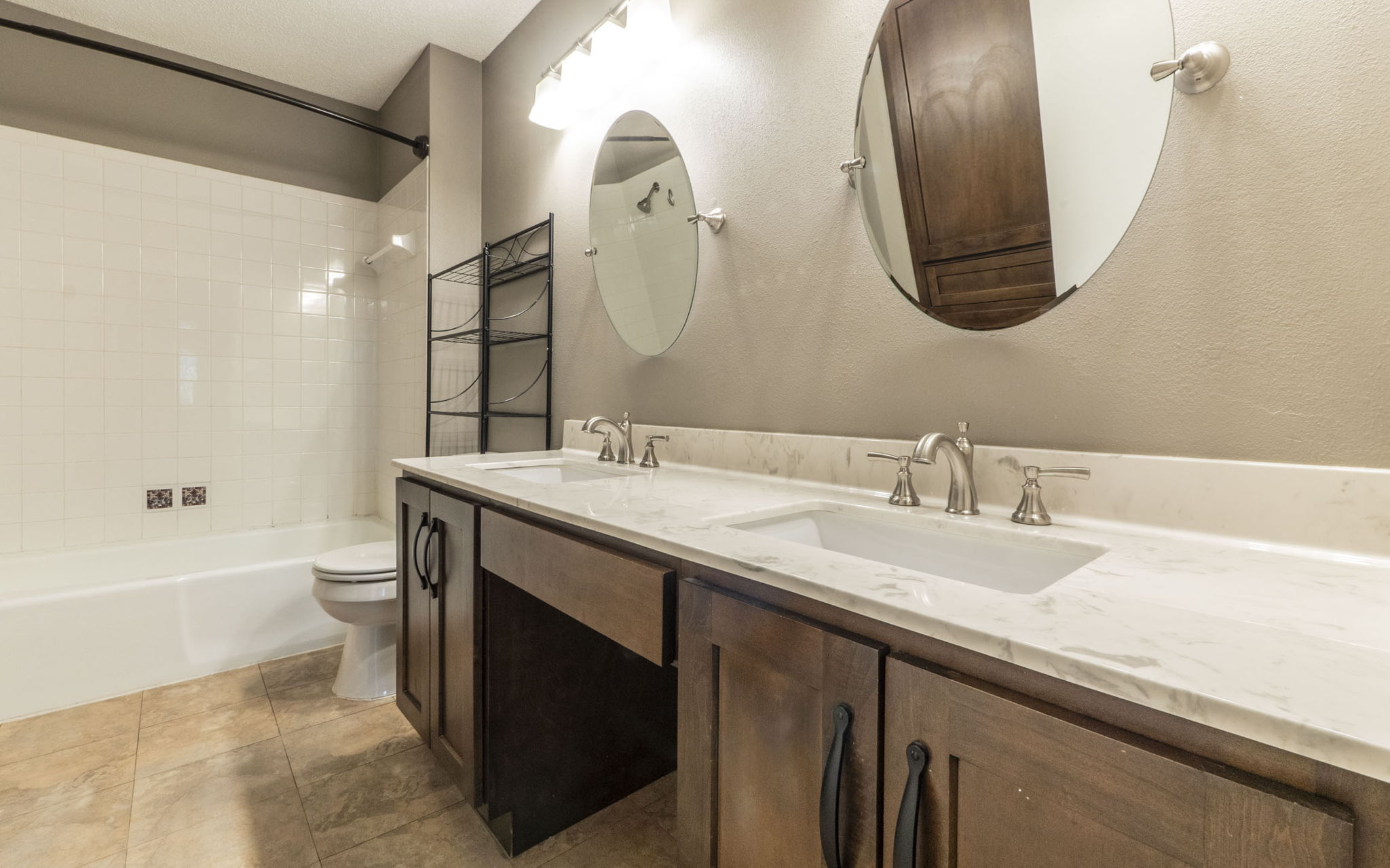 1007 Markham Lane, Unit A Austin, TX 78753 - Photo 9 of 15 a bathroom with a double vanity sink and a mirror