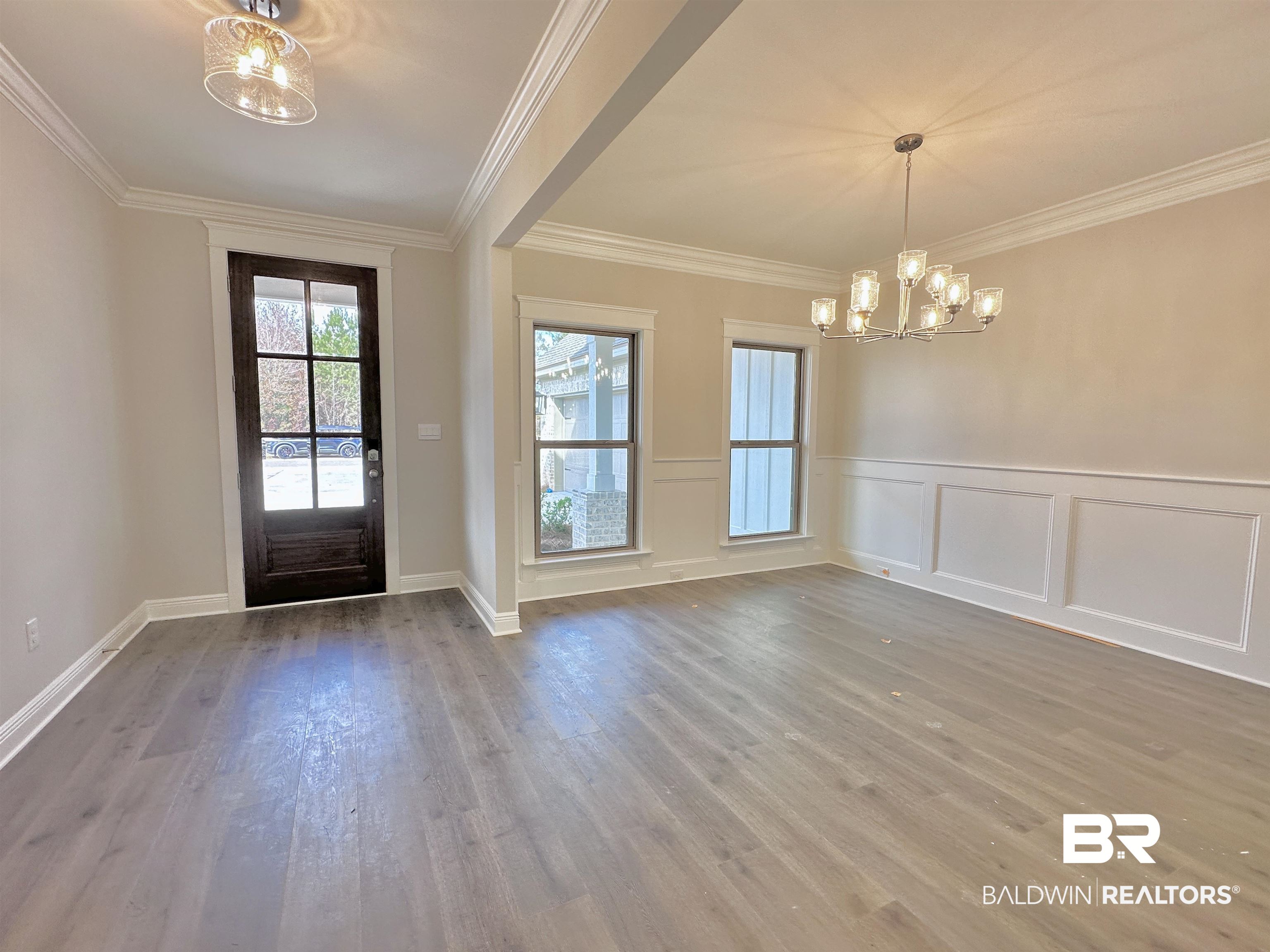 630 Kitfox Avenue Fairhope, AL 36532 - Photo 4 of 40 Foyer entrance with an inviting chandelier, hardwood / wood-style flooring, and ornamental molding