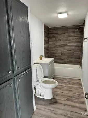 a bathroom with a toilet and a shower