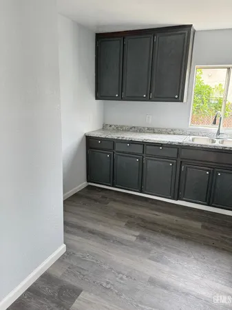a kitchen with granite countertop cabinets and window