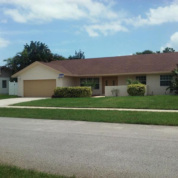 4868 Fox Hunt Trail Boca Raton, FL 33487 - Photo 1 of 8 a front view of a house with a yard