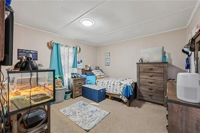 a bedroom with furniture and a flat tv screen