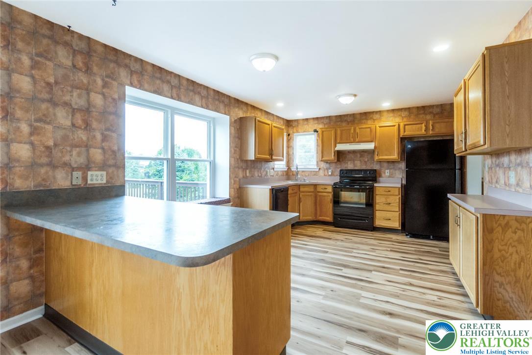 2226 Red Maple Drive Coplay, PA 18037 - Photo 11 of 69 a kitchen with stainless steel appliances granite countertop a sink a stove and a refrigerator