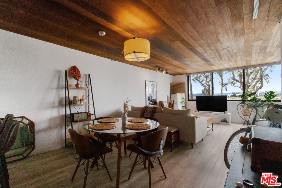 6209 Pacific Avenue, Unit 103 Playa del Rey, CA 90293 - Photo 8 of 40 a view of a dining room with furniture and wooden floor