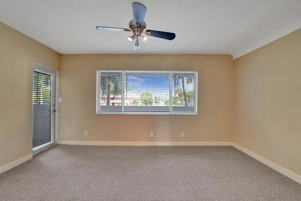 2895 Northeast 32nd Street, Unit 206 Fort Lauderdale, FL 33306 - Photo 6 of 22 an empty room with windows and fan