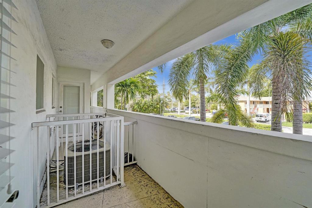 2895 Northeast 32nd Street, Unit 206 Fort Lauderdale, FL 33306 - Photo 9 of 22 a view of porch with yard