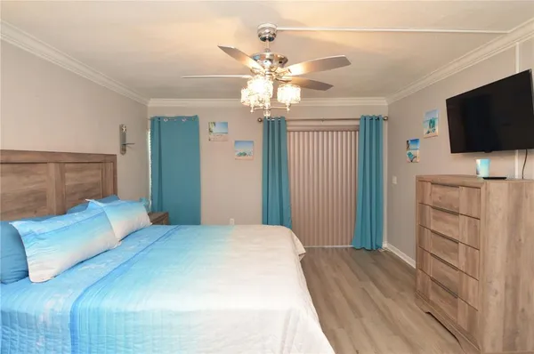 a bedroom with a bed and a flat screen tv in it