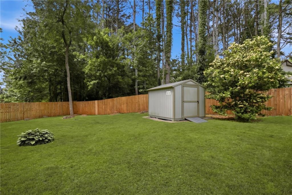 338 Arbour Way Suwanee, GA 30024 - Photo 27 of 32 a view of a backyard with large trees