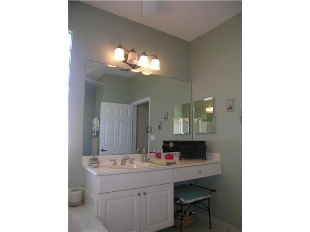 2927 Southeast Racoon Way Stuart, FL 34997 - Photo 11 of 22 a bathroom with a sink and a mirror