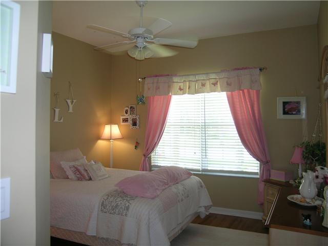 2927 Southeast Racoon Way Stuart, FL 34997 - Photo 12 of 22 a bedroom with a bed and a window