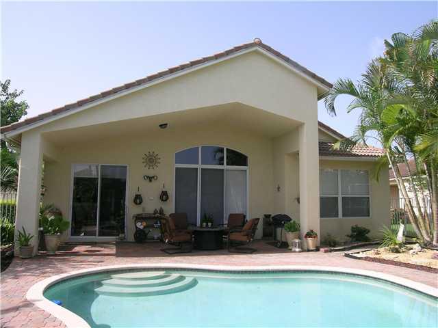2927 Southeast Racoon Way Stuart, FL 34997 - Photo 16 of 22 a front view of a house with a yard
