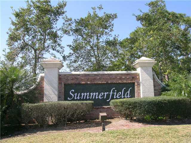 2927 Southeast Racoon Way Stuart, FL 34997 - Photo 17 of 22 a view of a street sign under a large tree